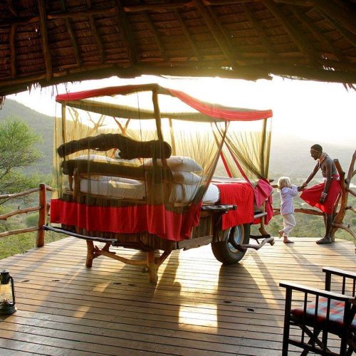 A maasai guide with a kid at Loisaba Star Bed telling tales making of a great family safari